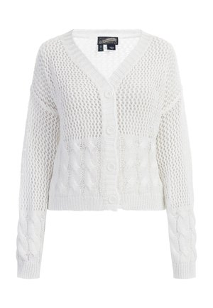 Balts adīts kardigans ar V-veida kakla izgriezumu, kam ir acu raksts un kabelīšu adījuma akcenti. Četras pogas pa priekšu, īsās garuma.