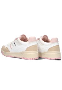 White and beige sneakers with pink accents, featuring a textured suede and mesh upper, rounded toe, and thick rubber sole.