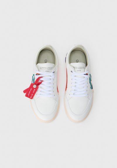 Witte leren sneakers met kleurrijke accenten in rood, groen en blauw. Voorzien van platte witte veters en een prominente rode label. Gevormde zool.