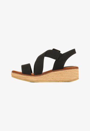 Sandale compensée noire avec des brides croisées et une semelle plateforme tressée beige, bout ouvert et bride arrière réglable.