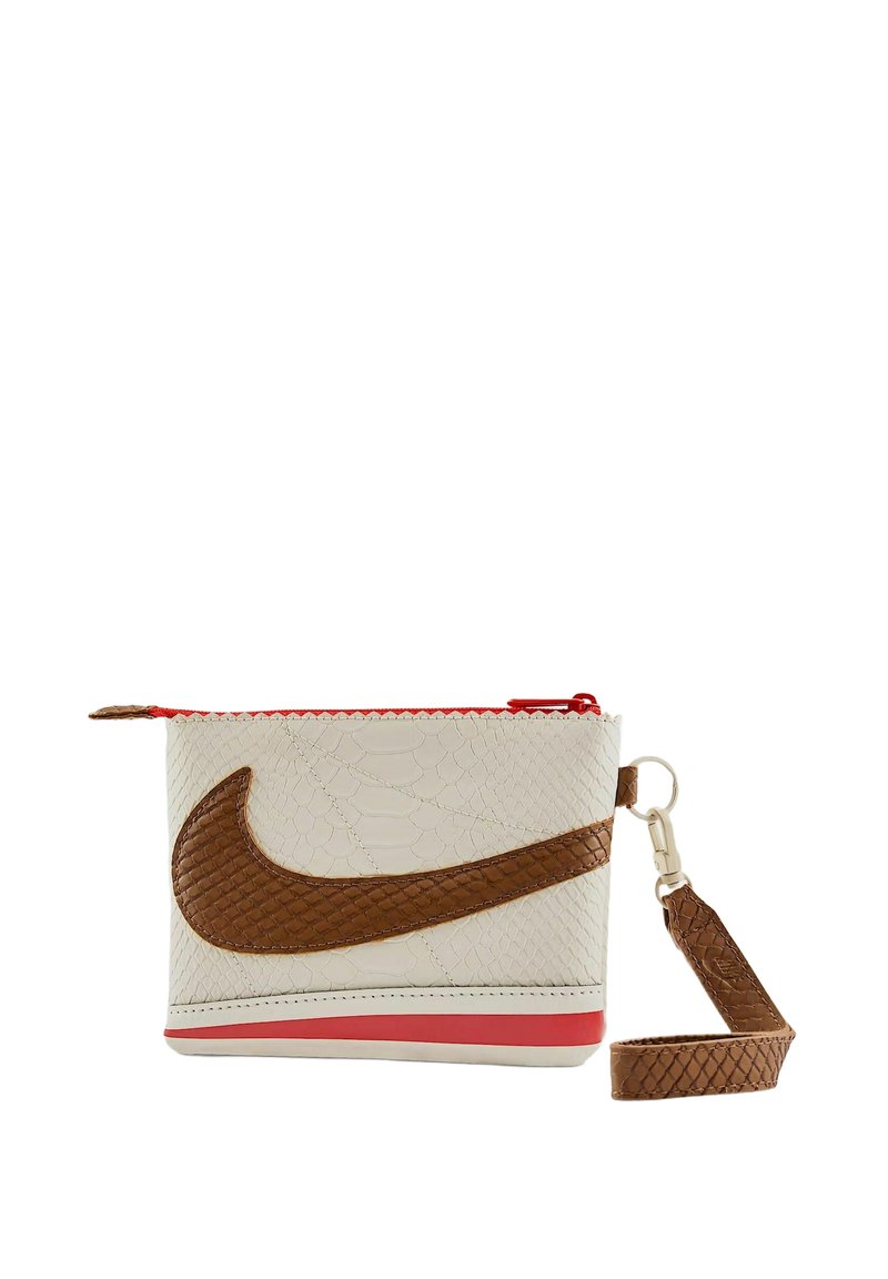 Pochette Nike realizzata in pelle bianca testurizzata con un logo swoosh marrone. Presenta una cerniera rossa e un cinturino da polso marrone staccabile.