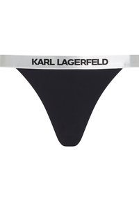 Tanga nero con una ampia fascia elastica argentata con la scritta "KARL LAGERFELD" stampata in nero. Tessuto liscio, design minimal.