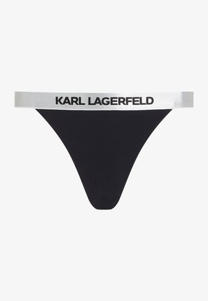 Tanga nero con una ampia fascia elastica argentata con la scritta "KARL LAGERFELD" stampata in nero. Tessuto liscio, design minimal.