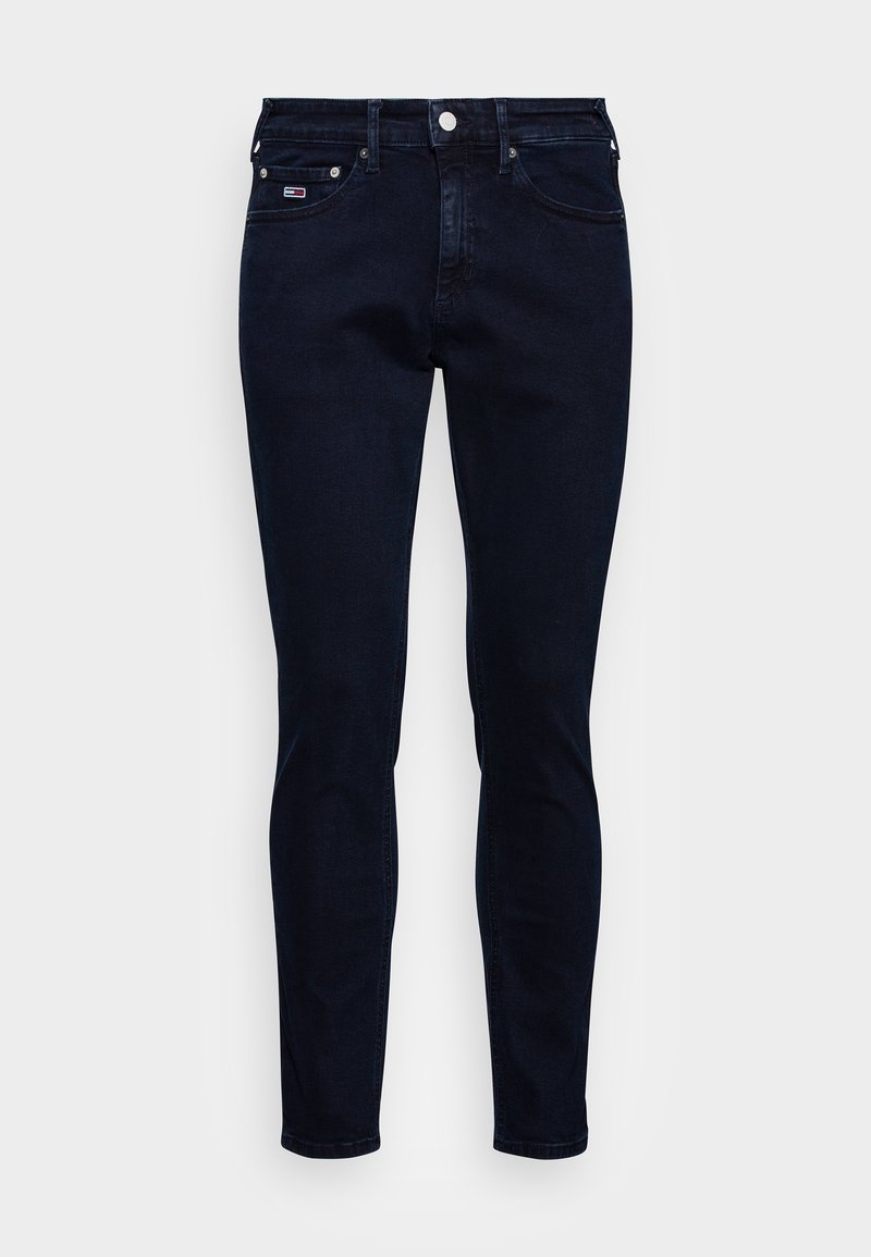 Tummansiniset slim-fit farkut, joissa on etu- ja takataskut, vyölenkit sekä pieni suorakaiteen muotoinen logo oikeassa etutaskussa.