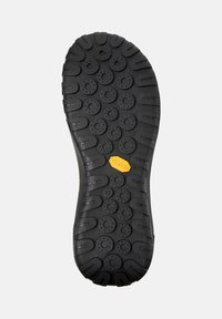 Suola di scarpa in gomma nera con superficie strutturata, caratterizzata da motivi circolari e logo Vibram in giallo. Taglia indicata come 42.
