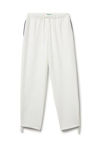 Bílé tepláky vyrobené z měkké tkaniny, s elastickým pasem a šňůrkou, bočními kapsami a zúženými manžetami.