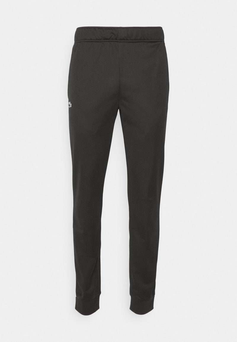 Pantalons de jogging noirs ajustés avec une taille élastique et un petit logo blanc sur la cuisse gauche, poignets côtelés aux chevilles.