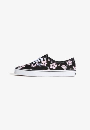 Sort Vans-sneaker med hvid sål og pink blomsterprint, hvide snørebånd og synligt mærke på siden.
