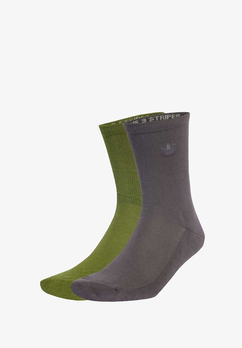 Calze a crew in cotone verde e grigio. Texture a costine, punta rinforzata e polsini elasticizzati. Presenta un piccolo logo vicino al polsino.