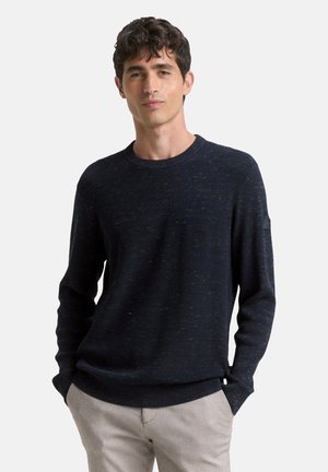 Navy knitted sweater with a textured finish, crew neckline, and long sleeves. Features a subtle pattern and ribbed cuffs and hem.