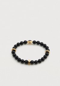 Βραχιόλι με μαύρες χάντρες και χρυσαφένιες λεπτομέρειες. Εναλλασσόμενες γυαλιστερές μαύρες μπάλες και χρυσές μεταλλικές λεπτομέρειες, με υφή εξαγωνικού σχήματος.