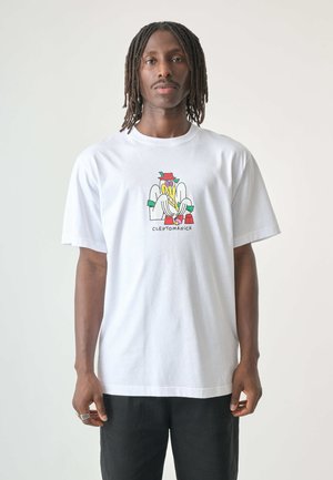 White cotton t-shirt featuring a graphic of a cartoon character with a colorful design, black text reading "CLEPTOMANICK" below the image.
