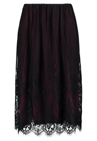 Gonna nera plissettata con un sopraccoperta in pizzo trasparente all'orlo. Presenta una finitura testurizzata e una vita elastica per una vestibilità regolabile.