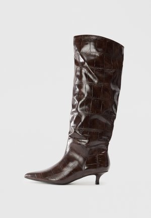 Dark brown knee-high leather boot with crocodile texture, pointed toe, and low kitten heel.
