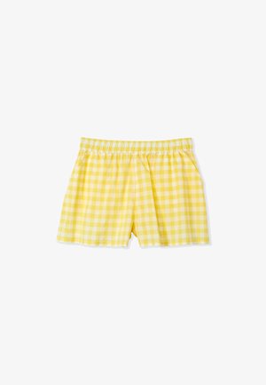 Shorts à carreaux jaunes avec une taille élastique, dotés de poches latérales et d'une bordure en dentelle le long de l'ourlet. Matière en coton doux.