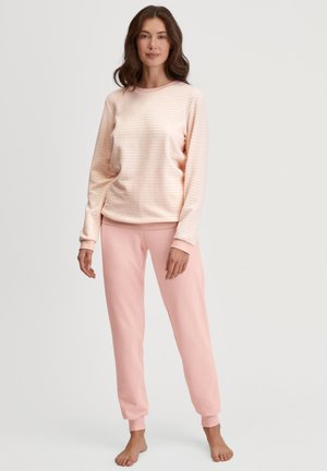 Hellrosa Loungewear-Set bestehend aus einem langärmligen gestreiften Oberteil und dazu passenden einfarbigen rosa Hosen mit Rippbündchen und lockerer Passform. Weiche Textur.