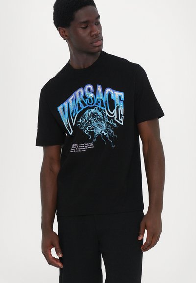 Black cotton T-shirt featuring a blue and silver graphic print of a jellyfish and "VERSACE" text. Short sleeves and a classic fit.
