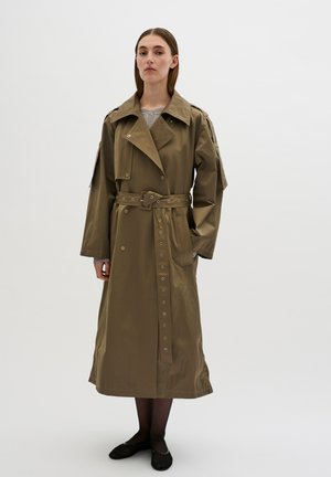 Khaki trench coat in a smooth, lightweight fabric. Features a double-breasted design, belt, snap buttons, and side pockets. Long sleeves.