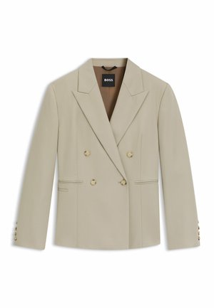 Beige double-breasted blazer with peaked lapels, four gold button accents, side pockets, and a smooth, textured fabric.