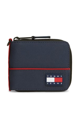 Kompakten temno moder denarnica z zadrgo, rdečim robom in Tommy Jeans logotipom spredaj.