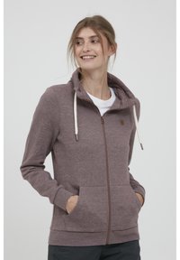 Malva zip-hoodie med dragsko, framfickor och en mjuk textur. Designad med en figurnära passform och ribbade ärmslut.