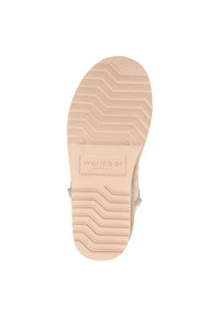 Beige schoenzool met horizontaal zigzagprofiel, "Warmbat Australia" logo en een gladde textuur.