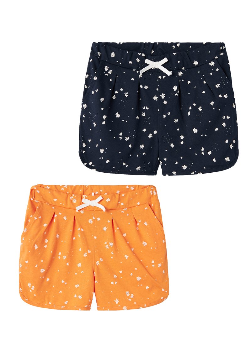 Two pairs of shorts: one navy with white floral print and one orange with a similar pattern. Both feature an elastic waistband and bow detail.