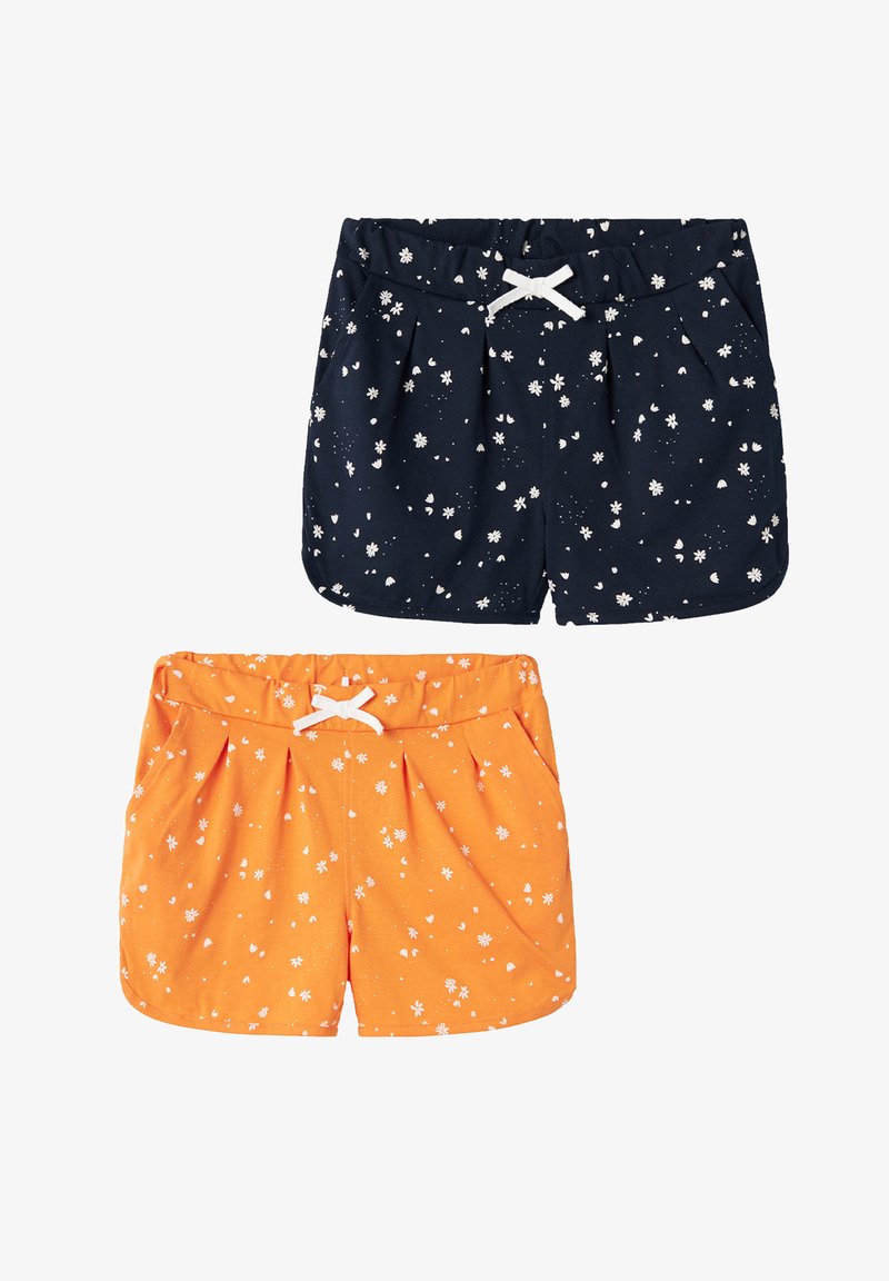 Two pairs of shorts: one navy with white floral print and one orange with a similar pattern. Both feature an elastic waistband and bow detail.