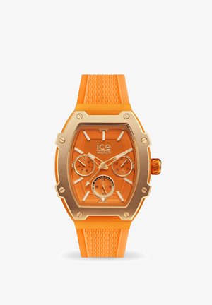 Orologio in silicone arancione con cassa in acciaio inossidabile dorato, forma esagonale, tre sottodial, cinturino texturizzato e marcatori delle ore chiari e audaci.