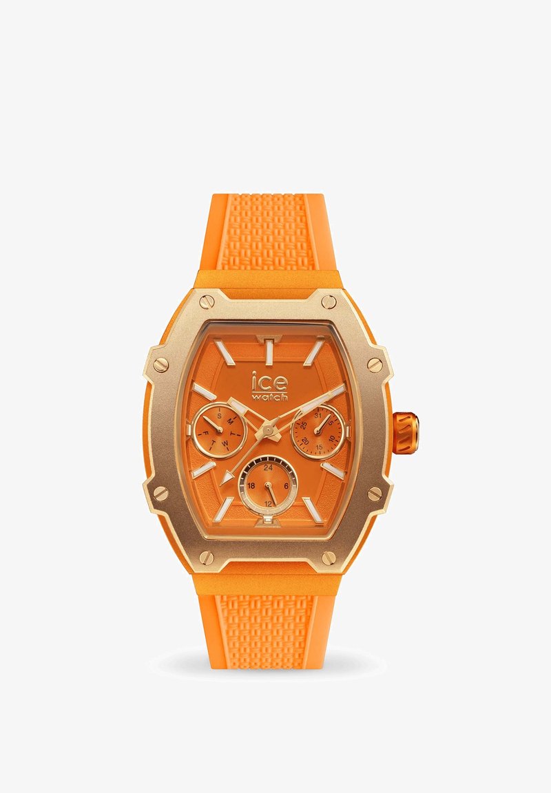 Reloj de silicona naranja con una caja de acero inoxidable de tono dorado, forma hexagonal, tres subesferas, correa texturizada y marcadores de hora claros y gruesos.