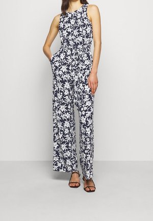 Floraler Overall mit figurbetontem Oberteil, weiten Beinen, marineblauem Hintergrund und weißem Blumenmuster. Mit Seitentaschen und ärmellosem Design.