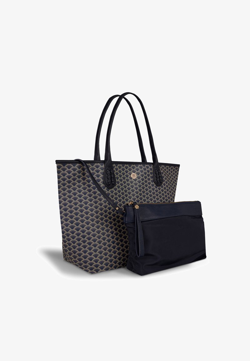 Navy tote bag with gold scallop pattern, leather trim, dual handles, and a detachable zippered pouch in solid navy fabric.