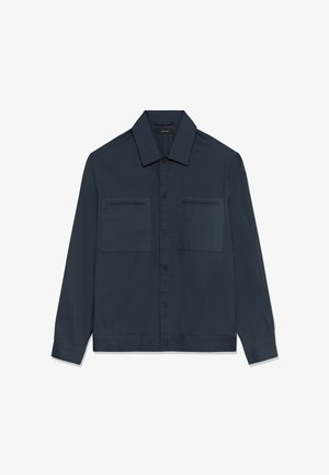 Tumši zila garroku krekla jaka ar apkakli, priekšējām sprādzēm un divām krūšu kabatām ar horizontālām atverēm.