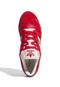Red suede and leather sneaker with white stripes and laces. Features a large logo on the tongue and perforation details on the toe cap.