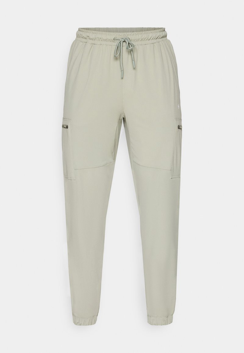 Pantaloni jogger verde chiaro realizzati in tessuto leggero, con vita elastica, cordoncino e due tasche laterali.