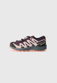 Purple and black athletic shoe with a mesh upper, textured accents, quick-lace system, and a pink rubber sole. Features logo on heel.