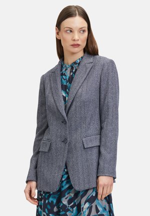 Tailored navy herringbone blazer with two buttons, notch lapels, and front pockets. Features structured shoulders and a slightly textured fabric.