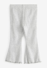 Pantalons en velours côtelé gris à pattes d'éléphant avec une texture douce et des ourlets festonnés. Le matériau est léger et extensible pour plus de confort et de liberté de mouvement.