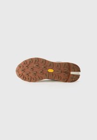 Rubber shoe sole with a brown traction pattern, featuring a yellow logo. The sole has a thick, textured design ideal for grip.