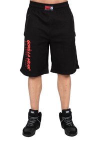 Black athletic shorts with textured fabric, featuring red "GORILLA WEAR" branding on the left leg and side pockets. Worn with black shoes.