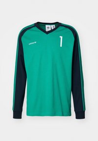 Vihreä ja musta Adidas pitkähihainen urheilupaita, jossa on numero 1 edessä ja Adidas-logo vasemmassa rinnassa.