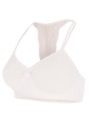 Licht beige draadloze bh met een V-hals ontwerp, een decoratieve strik in het midden en kantaccenten op de racerback banden. Effen textuur.