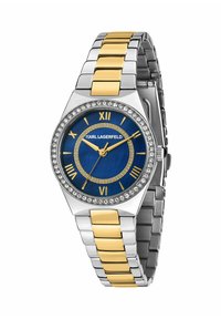 Silver- och guldfärgad metallarmbandsur med blå urtavla, romerska siffror och kristalldetaljer runt boetten. Elegant armbandsdesign.