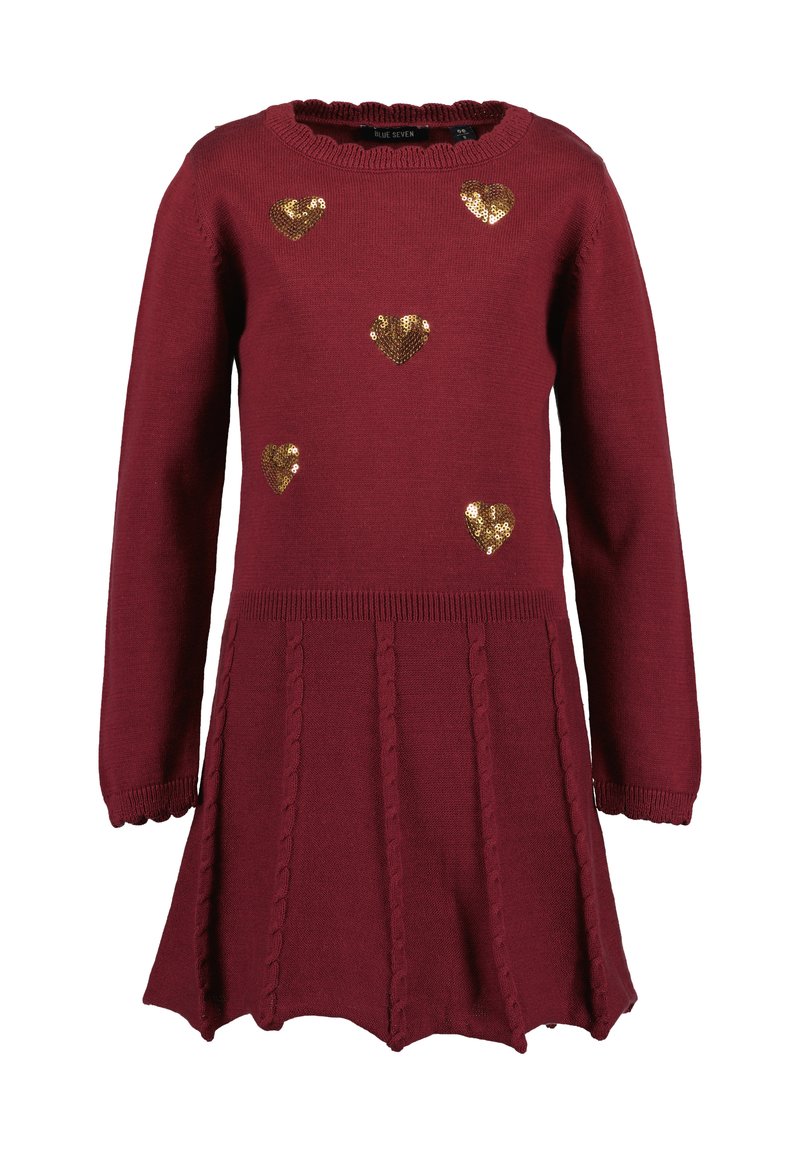 Burgundy neulemekko, jossa on pitkät hihat, aallotettu helma ja kultaiset paljetti sydänkoristeet. Teksturoitu palmikkoneule yhdistelmä hameessa.