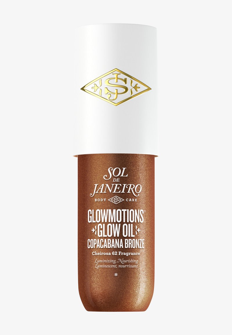 Flacon de Sol de Janeiro Glowmotions Glow Oil en Copacabana Bronze avec un bouchon blanc et un logo doré sur le dessus.