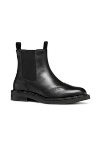 Stivali Chelsea in pelle nera con pannelli elastici laterali, dettagli brogue sulla punta e suola piatta in gomma. Design minimalista.