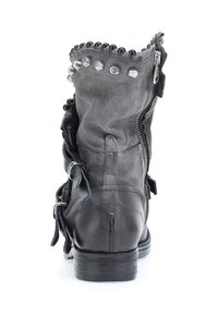 Black leather ankle boot featuring a textured finish, decorative studs along the top, side zipper, and lace accents on the sides.