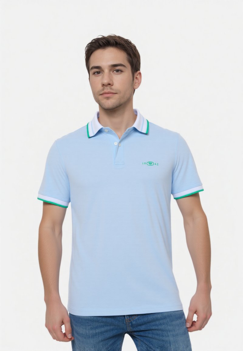 Helles blaues Polohemd aus weichem Stoff, mit einem Kragen in Weiß und Grün sowie einem kleinen grünen Logo auf der Brust.