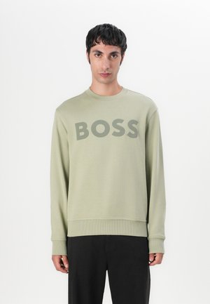 Light green sweatshirt made from cotton blend with long sleeves and a round neck. Features large "BOSS" logo in darker green across the chest.