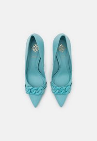 Turquoise high-heeled pumps with pointed toes and a braided strap detail across the front. Smooth leather finish and cushioned interior.